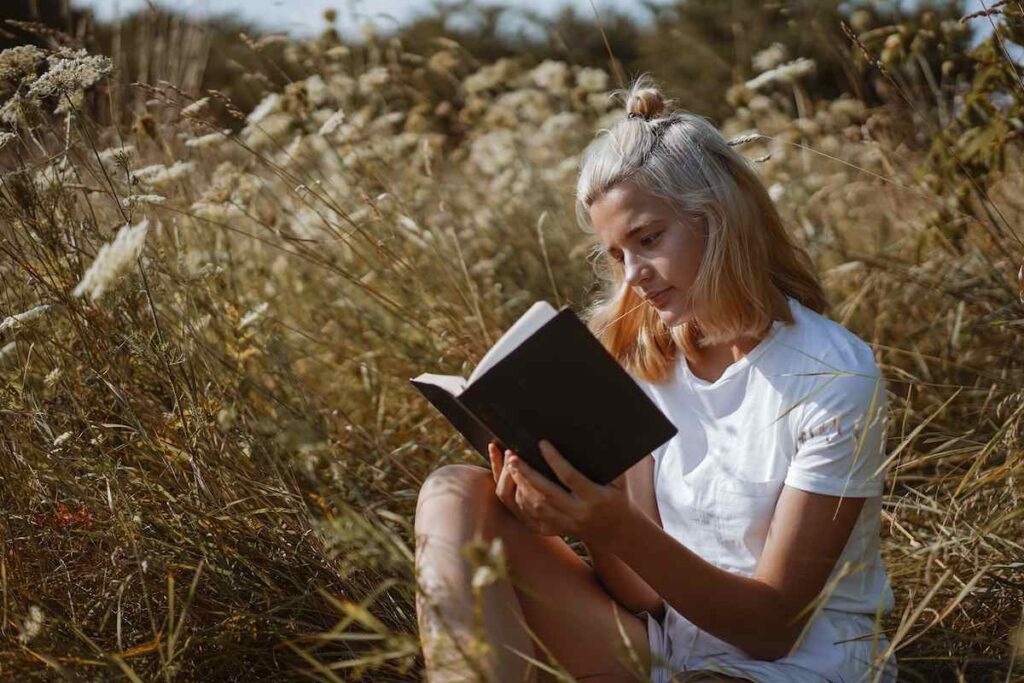 A girl reading the bible in God's presence.