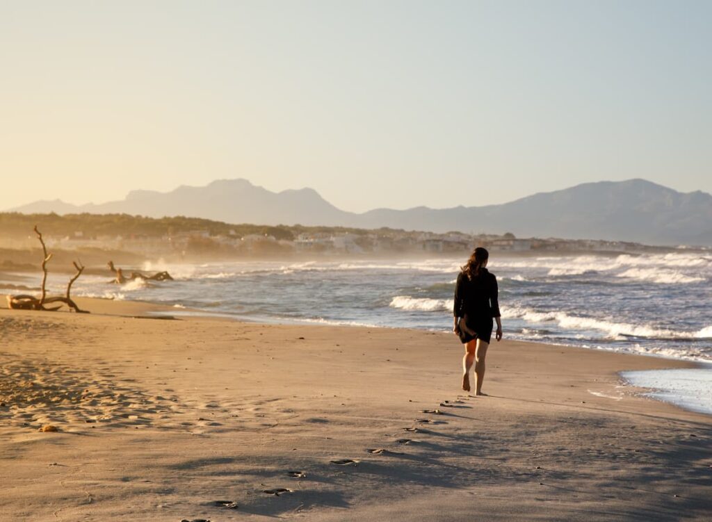 A woman walking on beach.